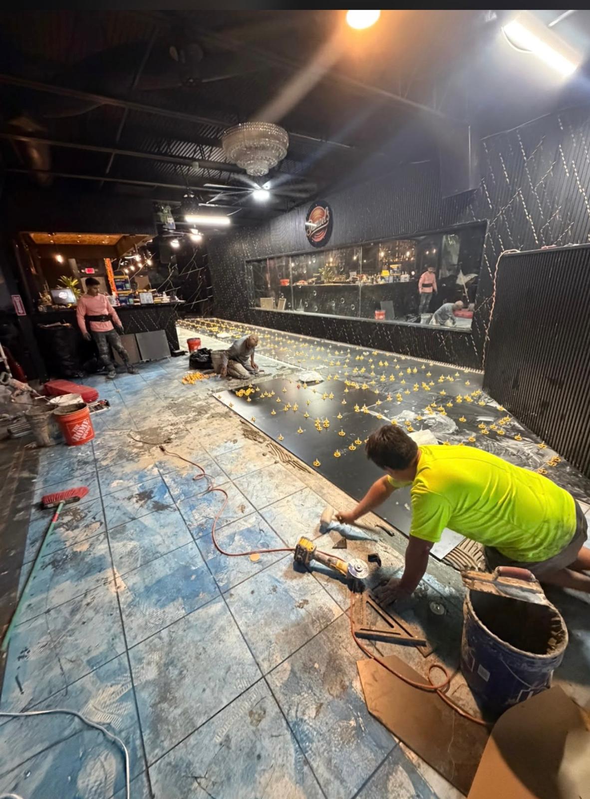 Nightclub lounge black floor installation in progress